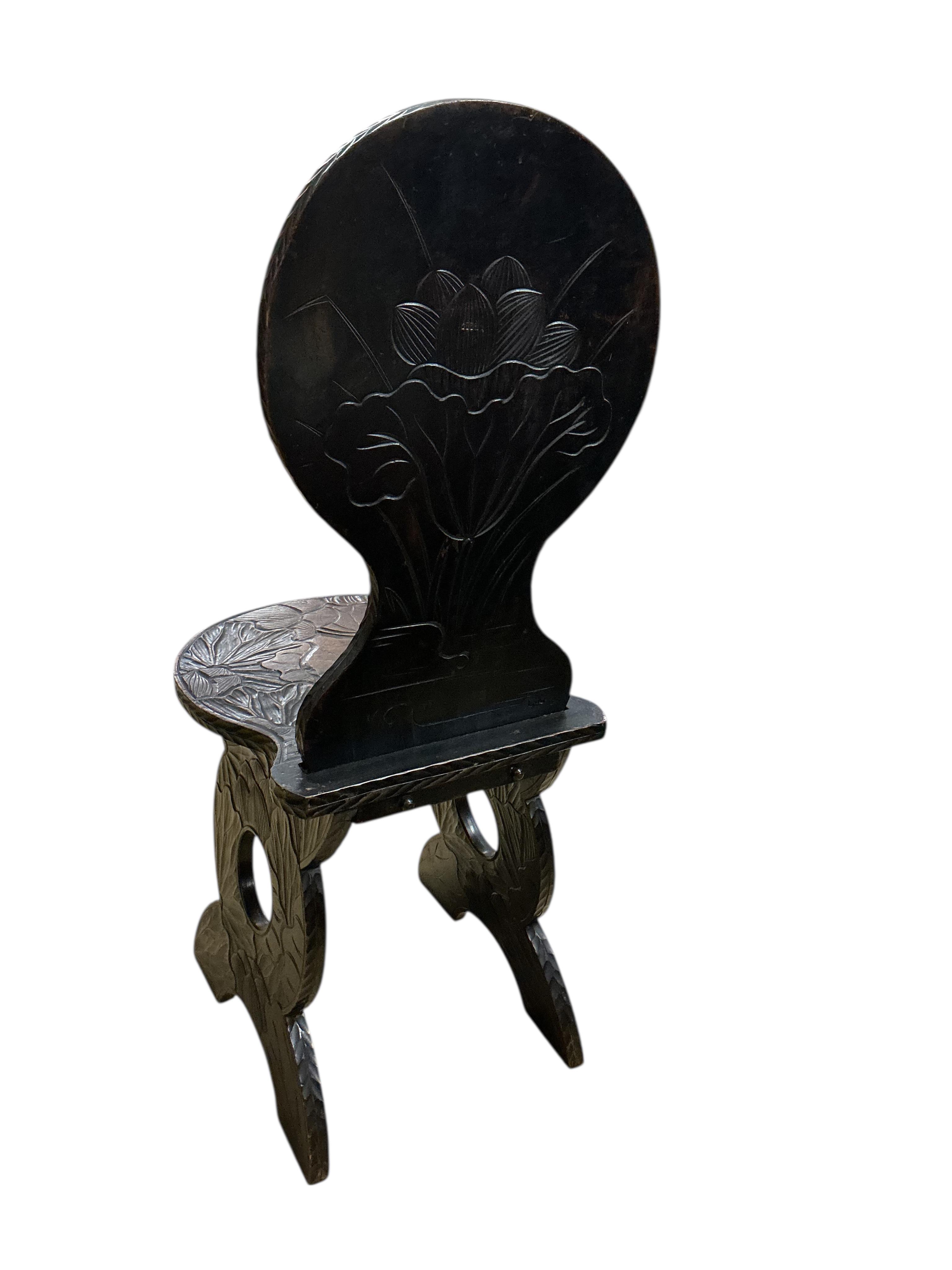 A Japanese carved hardwood hall chair for Liberty, width 39cm, depth 44cm, height 100cm